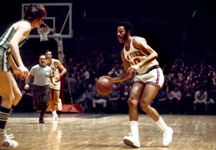 New York Knicks guard Walt Frazier dribbles the ball against the Atlanta Hawks defense.
